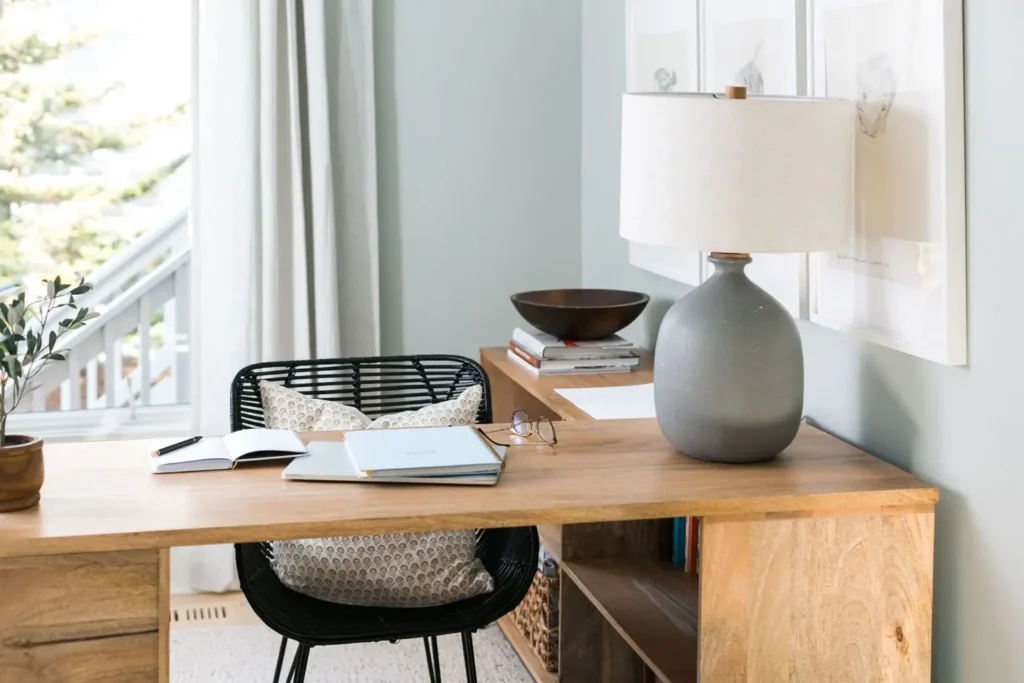 A table with a lamp and book on it